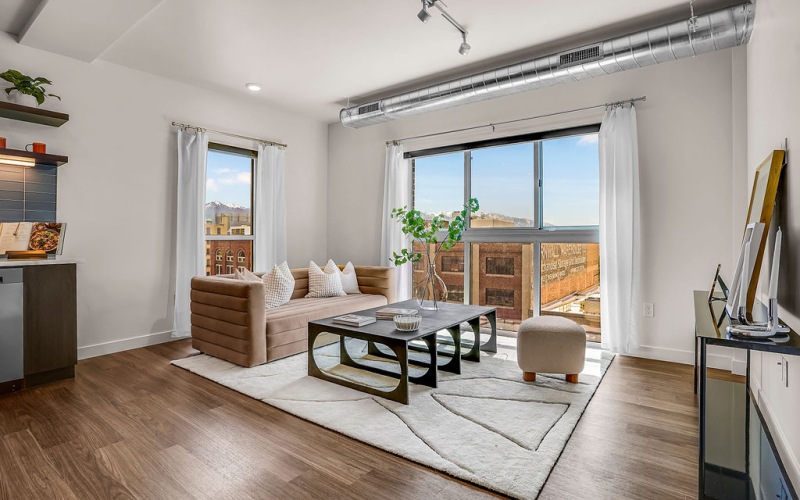 oversized windows brighten spacious, furnished living room