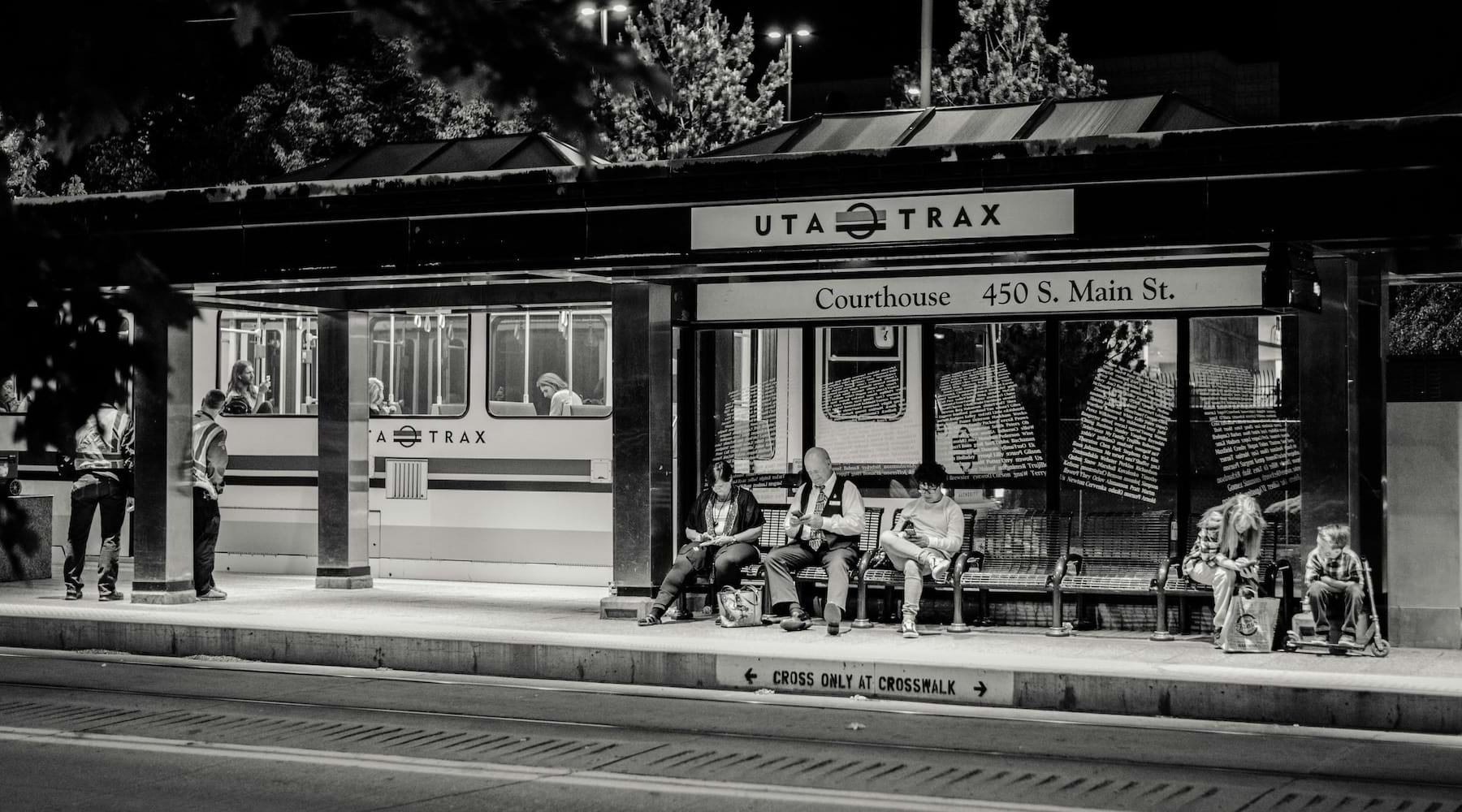 train station with people waiting on a bench
